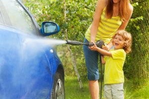 mom and son with rented pressure washer